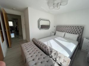 a bedroom with a bed and a mirror in it at Flat On The Shore in Edinburgh