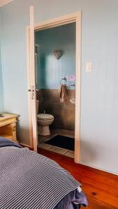 a bedroom with a bathroom with a toilet and a sink at Campismo Ninho Villa 26 - Ponta Malongane in Ponta Malongane