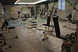 a gym with several rows of treadms and machines at Park Hotel Italia in Tezze sul Brenta