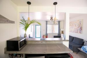 a living room with a tv on a table at Casa Limonada Boutique Motel in Sarasota +259 photos