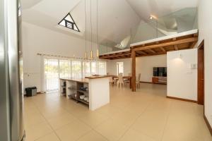 a large kitchen with a large glass ceiling at Tropical Villa by Fabular Villas & Hotels in Rivière Noire