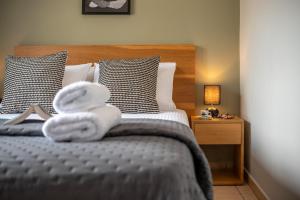 a bedroom with a bed with towels on it at Alexandros Luxury House in Falasarna +72 photos