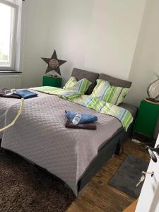 a bedroom with a bed with two towels on it at Les chineurs du 81 in Liège