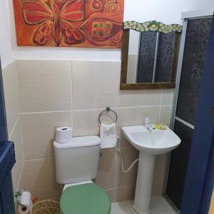 a bathroom with a toilet and a sink at Casarão do Pontal in Coruripe