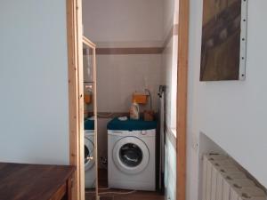 uma pequena casa de banho com uma máquina de lavar roupa e uma máquina de lavar roupa em A Cento Metri dal Mare em Senigallia