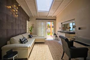 a living room with a white couch and a table at BlUE LAGOON in Costa Calma