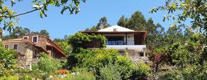 a house on the side of a hill with trees at Casa BelaVista Penela - Charming Guest House - Adults Only in Penela