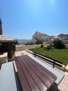a wooden bench sitting on top of a patio at Apartments Mikulić in Bol