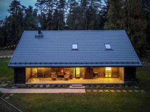 a house with a roof on top of it at Bergervilla Boutique Guest House & SPA in Mežmuiža