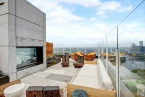 a balcony with a view of a building at Upscale Rainey St Condo Homes - Peloton, gym, rooftop pool, wifi included in Austin