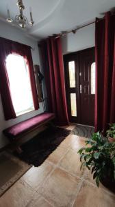 a living room with a bench and a window at Dom Sula in Ustrzyki Dolne