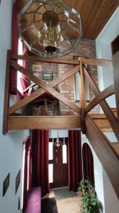 a room with a wooden ceiling and a chandelier at Dom Sula in Ustrzyki Dolne