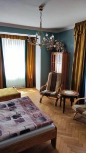 a bedroom with a bed and a chair and a table at Dom Sula in Ustrzyki Dolne