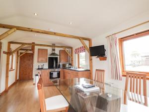 a kitchen and dining room with a glass table at Meikle Conval in Keith