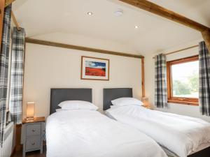 two white beds in a room with a window at Meikle Conval in Keith