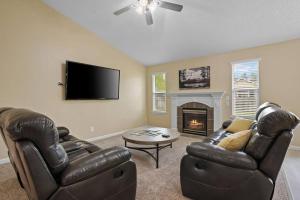 a living room with two leather chairs and a fireplace at Remodeled, Charming Retreat on the City's Doorstep in Boise