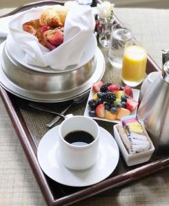 a tray with a cup of coffee and a plate of food at Mokara Hotel & Spa in San Antonio