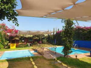 a swimming pool in a yard with a swimming pool at Jnane lkheir in Mansouria