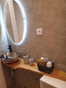 a bathroom with a sink and a mirror on a counter at Apartamento Cinema para férias em Esposende in Esposende