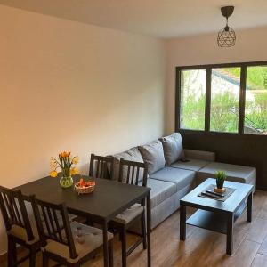 a living room with a table and a couch at Kosmajski raj in Nemenikuće