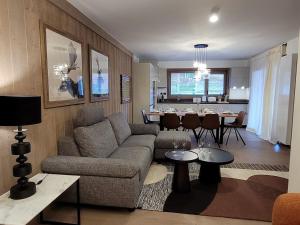 a living room with a couch and a dining room at Appartement Les Gets, 5 pièces, 8 personnes - FR-1-598-99 in Les Gets