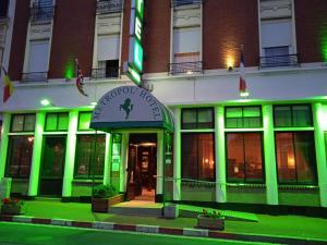 a building with a green light on the front of it at Metropol Hotel in Calais