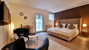 a bedroom with a large bed and a living room at Landhaus Kyritz in Kyritz