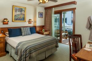 a bedroom with a bed and a balcony at The Avalon Hotel in Catalina Island in Avalon