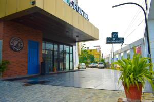 a building with a blue door on a street at Fortel in Chennai