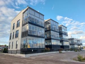 an apartment building with glass windows on the side of it at Hanko Holidays in Hanko