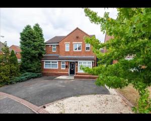 a brick house with a driveway in front of it at Marston 5 Bedroom Home With Parking Near NEC & BHX in Marston Green