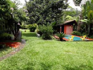 a backyard with a pool in the grass at Pousada Bom Bocado in São Pedro da Serra