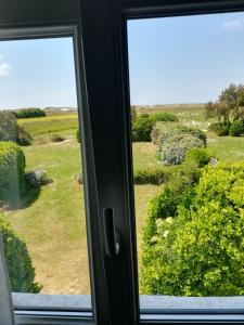 a window with a view of a field at TY MERVENT, l'océan à 500 m in Saint-Jean-Trolimon