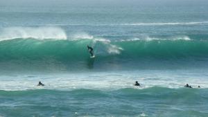 a person riding a wave on a surfboard in the ocean at TY MERVENT, l'océan à 500 m in Saint-Jean-Trolimon