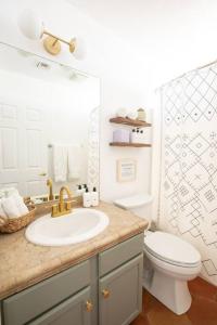 a bathroom with a sink and a toilet at Sun Runner - Serene desert home w/pool & hot tub in Twentynine Palms