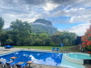 a swimming pool with a view of a mountain at Los Cruxes in Tepoztlán
