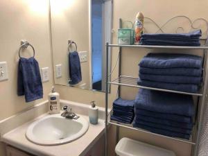 y baño con lavabo, espejo y toallas. en WelcomingTownhome - King Bed - Long Term Stays - UNC, en Chapel Hill