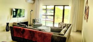 a living room with a couch and a window at InstaHomes by Tru - Villa in Blantyre