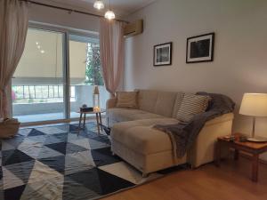 a living room with a couch and a window at Orion - Charming 1-bedroom condo at convenient location. in Melissátika