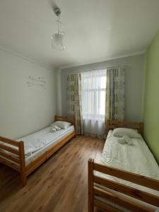 Voodi või voodid majutusasutuse Orange Cat Rooms toas