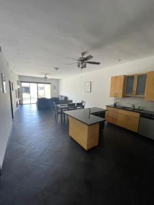 a kitchen and living room with a table and chairs at Caracoles Homes in Puerto Peñasco +54 photos