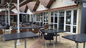 a row of tables and chairs outside of a restaurant at Mobil home 4-6 places St brėvin les pins 44 in Saint-Brevin-les-Pins