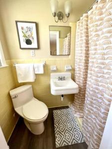 a bathroom with a toilet and a sink at *Comfortable Townhome * King Beds * Long Term* in Cary