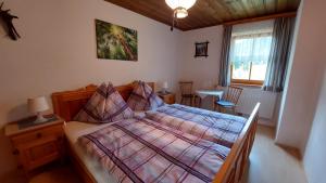 a bedroom with a bed and a table and a window at Spulhof in Abtenau