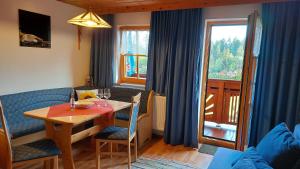 a dining room with a table and chairs and a window at Spulhof in Abtenau