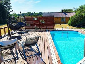 una terraza con 2 sillas y una piscina en Two-Bedroom Holiday home in Blidö 1, en Finnholmen