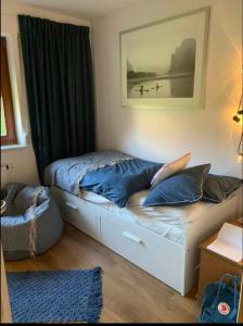 a bedroom with a bed with a picture on the wall at Bike - Apartament Ustroń Orzechowa 66 in Ustroń