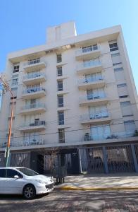 a white car parked in front of a building at Departamento126 in Junín