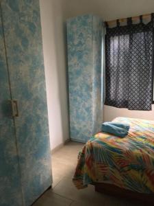 a bedroom with a bed and a window at Villa Mar Sosua in Sosúa