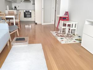 a kitchen and living room with a table and chairs at Izzy - 5 min walk from the main square in Zagreb +7 photos